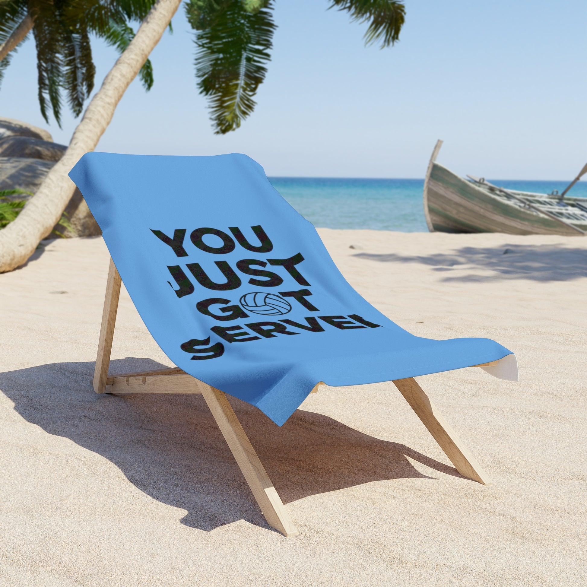 Towel with You Just Got Served slogan beside volleyball gear.