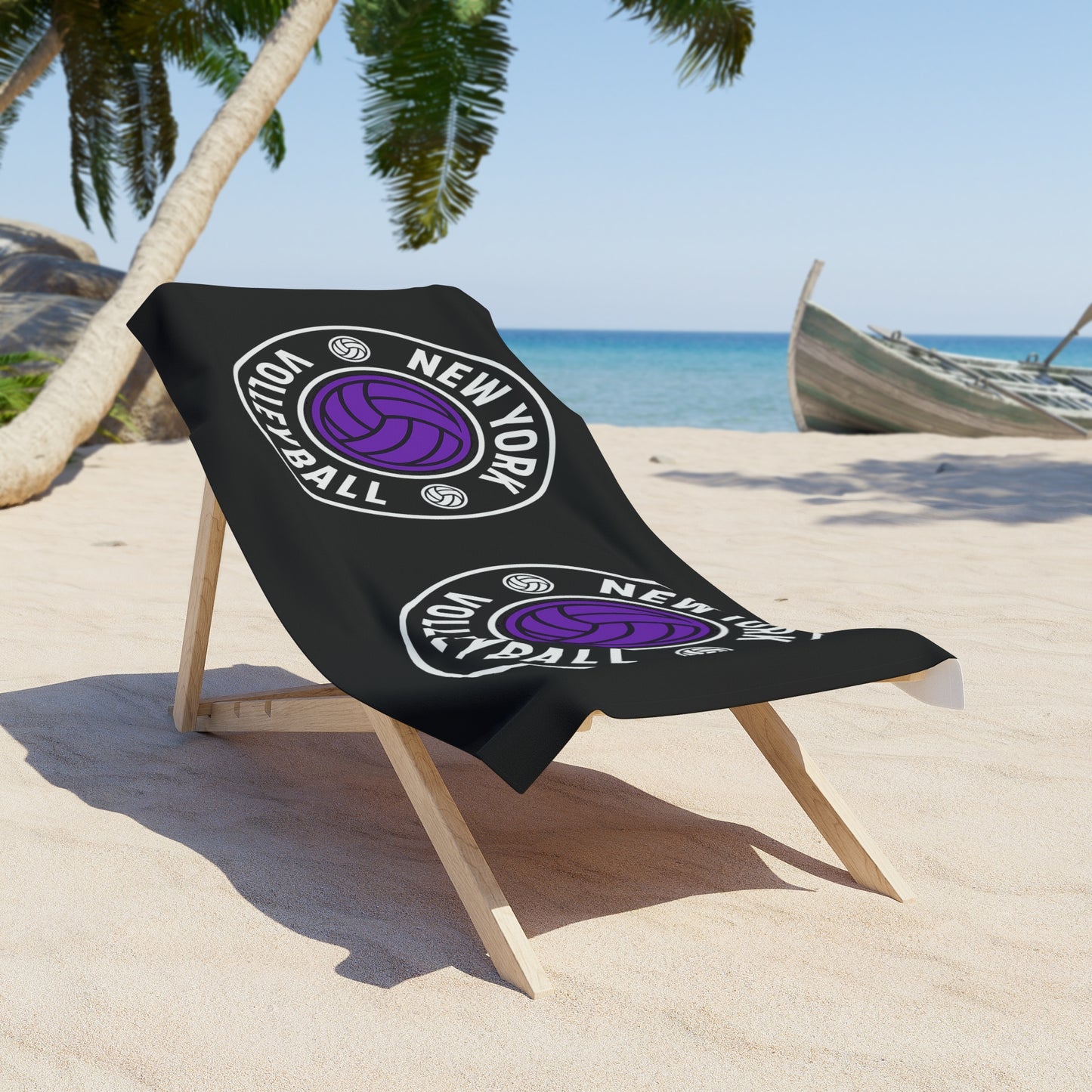 Volleyball beach towel in purple and black displayed by poolside