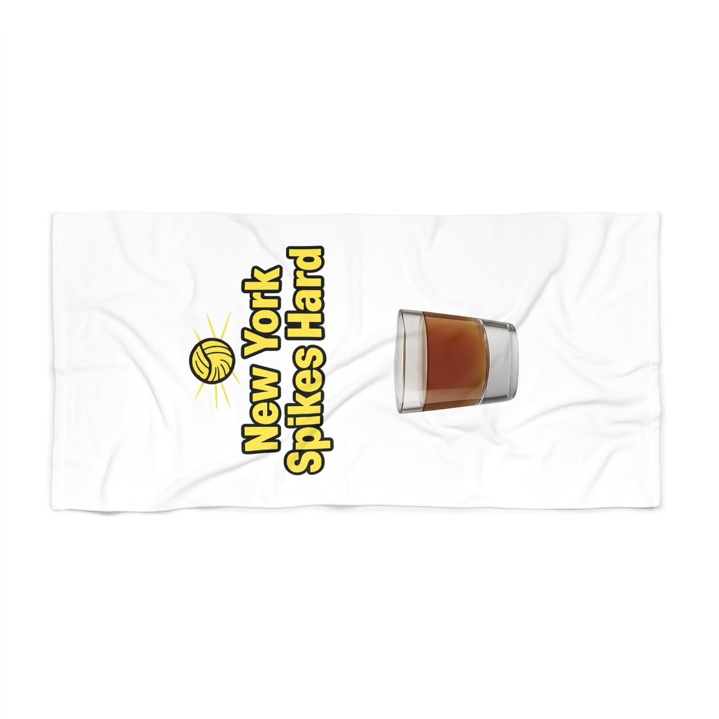 New York Spikes Hard beach towel with bold front graphic laid out on sand.